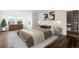 Bright bedroom with hardwood floors, a plush bed, and natural light from large windows at 1983 Candleglow St, Castle Rock, CO 80109