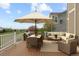 Spacious deck area with patio seating, an umbrella, and a scenic view of the surrounding landscape at 1983 Candleglow St, Castle Rock, CO 80109