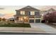 Charming two-story home with a covered porch, attached garage, and beautiful landscaping at 1983 Candleglow St, Castle Rock, CO 80109