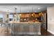 Gourmet kitchen features a center island with seating, stainless steel appliances, and custom cabinetry at 1983 Candleglow St, Castle Rock, CO 80109