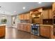 Beautiful kitchen with rich wood cabinets, granite countertops, and stainless steel oven at 1983 Candleglow St, Castle Rock, CO 80109