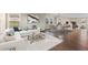 Bright and airy living room with elegant furniture, large windows, and hardwood floors throughout at 1983 Candleglow St, Castle Rock, CO 80109