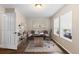 Cozy home office with a sleek desk, stylish shelving, and great natural light from large windows at 1983 Candleglow St, Castle Rock, CO 80109