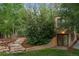 The backyard has a stone retaining wall, stone steps, and mature trees and shrubs at 510 16Th St, Golden, CO 80401