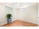 A clean basement area offers two windows, track lighting, and cork flooring at 510 16Th St, Golden, CO 80401