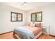 Bedroom with hardwood floors, two windows, and a bed at 510 16Th St, Golden, CO 80401