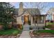 Charming brick home featuring a well-maintained yard with mature trees and colorful landscaping at 510 16Th St, Golden, CO 80401