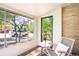 Sunroom featuring large windows, brick walls, and wicker furniture at 510 16Th St, Golden, CO 80401