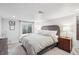 Neutral colored bedroom features a large bed, side tables, and a window at 4190 S Grant St, Englewood, CO 80113