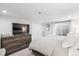 Modern bedroom with a large dresser, closet, and lots of natural light from the window at 4190 S Grant St, Englewood, CO 80113