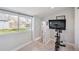 Bright bonus room features a stationary bike, a large window, and carpeted floors at 4190 S Grant St, Englewood, CO 80113