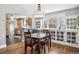 Bright dining area with built-in cabinets, wood floors, and a view into the kitchen at 4190 S Grant St, Englewood, CO 80113