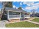 Charming home with a covered front porch, stone landscaping, and a well-manicured lawn at 4190 S Grant St, Englewood, CO 80113