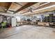 Spacious garage with shelving, storage bins, a refrigerator, and a concrete floor at 4190 S Grant St, Englewood, CO 80113