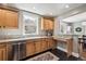 Bright kitchen features granite countertops, stainless steel appliances, and wooden cabinets at 4190 S Grant St, Englewood, CO 80113
