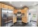 Updated kitchen boasts stainless steel appliances, ample storage, and sleek black tile floors at 4190 S Grant St, Englewood, CO 80113