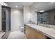 Bright bathroom featuring double sinks with marble countertop, and modern gray tiled shower stall at 1401 Delgany St # 203, Denver, CO 80202