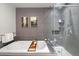 Bathroom featuring tub and shower combination, and gray tile accents at 1401 Delgany St # 203, Denver, CO 80202