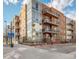 Contemporary brick apartment building featuring balconies and large windows, offering modern urban living at 1401 Delgany St # 203, Denver, CO 80202