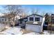 Two-story home with attached garage; features a white exterior at 8946 W Teton Cir, Littleton, CO 80128