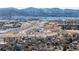 Aerial view of neighborhood near mountains and highway at 8946 W Teton Cir, Littleton, CO 80128