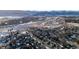 Aerial view of homes and highway with snowy landscape at 8946 W Teton Cir, Littleton, CO 80128