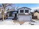 Two-story home with attached garage; features a white exterior at 8946 W Teton Cir, Littleton, CO 80128