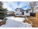 Spacious backyard with a patio and partial snow cover at 8946 W Teton Cir, Littleton, CO 80128