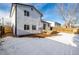 View of the home's back and snow-covered backyard at 8946 W Teton Cir, Littleton, CO 80128