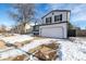 Two-story house with white siding, a two-car garage, and a snow-covered front yard at 8946 W Teton Cir, Littleton, CO 80128