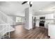 Modern kitchen with white cabinets, stainless steel appliances, and mosaic backsplash at 8946 W Teton Cir, Littleton, CO 80128