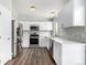 Modern kitchen featuring white cabinets and stainless steel appliances at 8946 W Teton Cir, Littleton, CO 80128