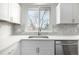 Kitchen sink with white cabinets and quartz countertops at 8946 W Teton Cir, Littleton, CO 80128