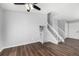 Bright living room with wood-look floors and staircase at 8946 W Teton Cir, Littleton, CO 80128