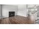 Living room with hardwood floors, fireplace, and view into the kitchen at 8946 W Teton Cir, Littleton, CO 80128