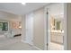 An open view of the bedroom and bathroom which shows carpet, tile, vanity and furniture at 5751 E Ithaca Pl # 3, Denver, CO 80237