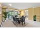 Charming dining area with a glass-topped table, seating for four, and access to the screened in porch at 5751 E Ithaca Pl # 3, Denver, CO 80237