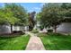 Charming home with a well-manicured lawn, mature trees, and a stone facade at 5751 E Ithaca Pl # 3, Denver, CO 80237