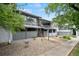 This property features a charming brick exterior, private patio, and upper-level sunroom with metal railings at 5751 E Ithaca Pl # 3, Denver, CO 80237