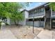 Charming brick exterior featuring a private patio and upper level sunroom with metal railings at 5751 E Ithaca Pl # 3, Denver, CO 80237