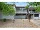 Charming brick exterior featuring a private patio and upper level sunroom with metal railings at 5751 E Ithaca Pl # 3, Denver, CO 80237