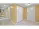 Well-lit hallway featuring tile floors and neutral colored walls at 5751 E Ithaca Pl # 3, Denver, CO 80237