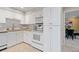 Efficient kitchen with white cabinetry and modern appliances at 5751 E Ithaca Pl # 3, Denver, CO 80237