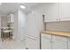 Kitchen showcases white appliances and ample storage space, with access to a cozy bar area at 5751 E Ithaca Pl # 3, Denver, CO 80237