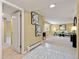 Bright living room featuring neutral decor, adjacent hallway, and wall art at 5751 E Ithaca Pl # 3, Denver, CO 80237