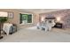 A large bedroom with wallpapered accent wall, bay window seat, and carpeted floor at 5751 E Ithaca Pl # 3, Denver, CO 80237