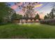Backyard with lush lawn, mature trees, outdoor dining set, creating a perfect outdoor space at 7034 S Cherry St, Centennial, CO 80122