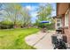 Expansive backyard featuring lush green lawn, mature trees, patio with seating, and play area, perfect for outdoor enjoyment at 7034 S Cherry St, Centennial, CO 80122