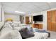 Relaxing finished basement with a cozy sectional sofa, entertainment center, and closet at 7034 S Cherry St, Centennial, CO 80122