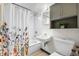 Cozy bathroom featuring a shower-tub combo with modern fixtures and tiled walls at 7034 S Cherry St, Centennial, CO 80122